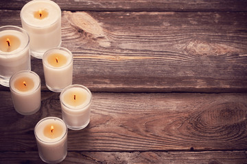 scented candles on old wooden background