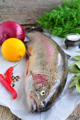 Fresh raw salmon with vegetables on a white background