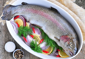Fresh raw salmon with vegetables on a white background