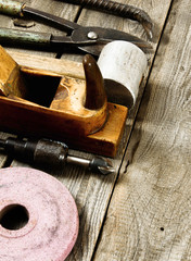 Many working tools on a wooden background.
