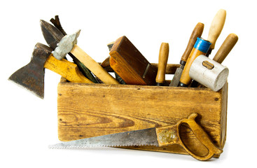 Working tools (saw, axe, chisel and others) in an old box on