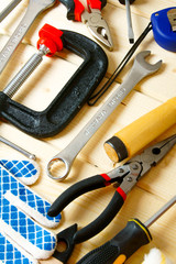 Many working tools on a wooden background.