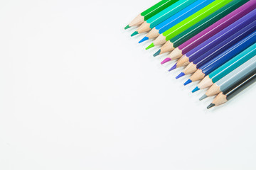 colored pencils on a white background
