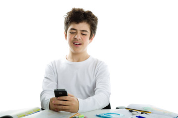 Boy smiles using smartphone on homeworks