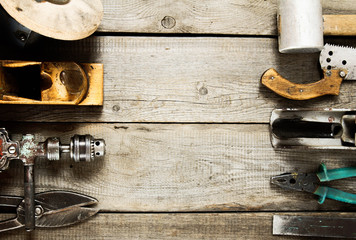 Many working tools on a wooden background.