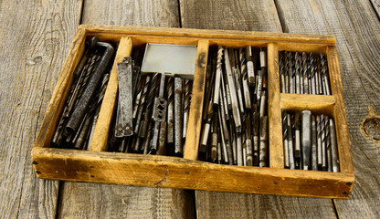 Fototapeta na wymiar box with drills on a wooden background.