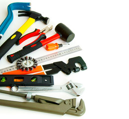 Many working tools - saw, axe, pliers and others on white