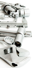 Metalwork. Spanner , ruler, caliper and others tools on white