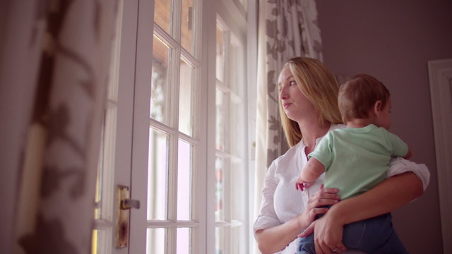 Sad Mother with her baby boy at home