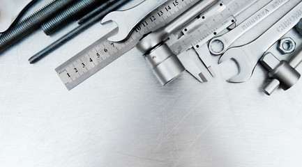 Fototapeta premium Metal tools on the scratched metal background.