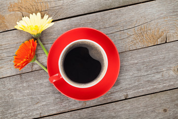 Cup of coffee and gerbera flowers