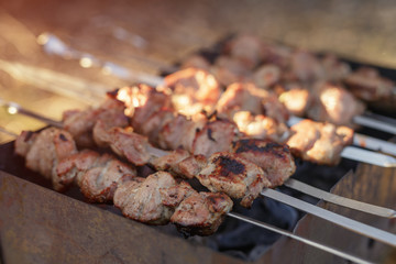 cooking pork shashlik on skewer in mangal outdoor food