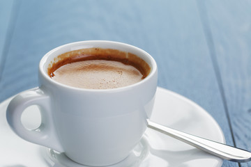 closeup of fresh espresso on light blue wooden table