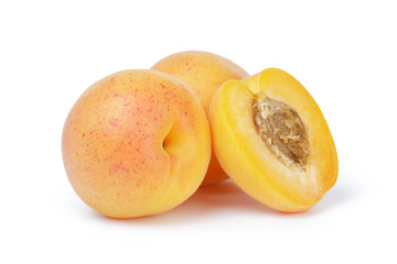 Naklejka na ściany i meble three ripe apricot fruits one half sliced isolated