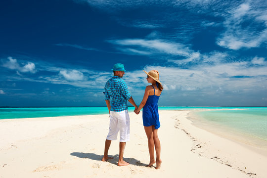 Couple in blue on a beach at Maldives