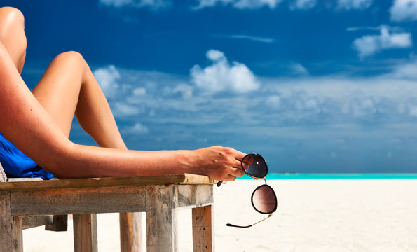 Woman At Beach Holding Sunglasses