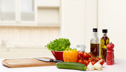 vegetables, spices and kitchenware on table