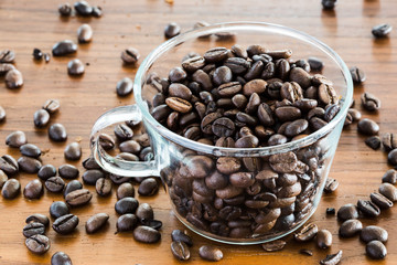 Coffee bean in a transparent cup on a wooden table