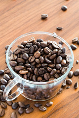 Coffee bean in a transparent cup on a wooden table