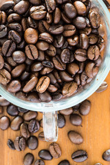 Coffee bean in a transparent cup on a wooden table
