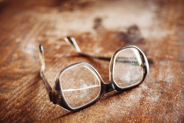 old glasses on wooden surface