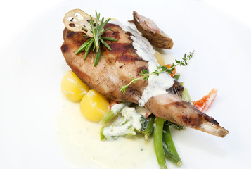 roasted rabbit meat and potatoes with vegetables