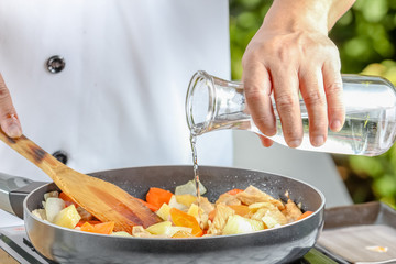 chef pouring  oil