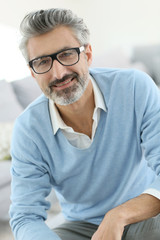 Smiling mature man with grey hair wearing eyeglasses