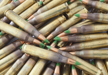 Pile of cartidges with green tipped bullets