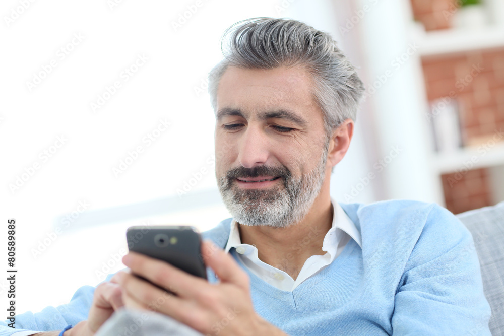 Canvas Prints mature man sending message with smartphone