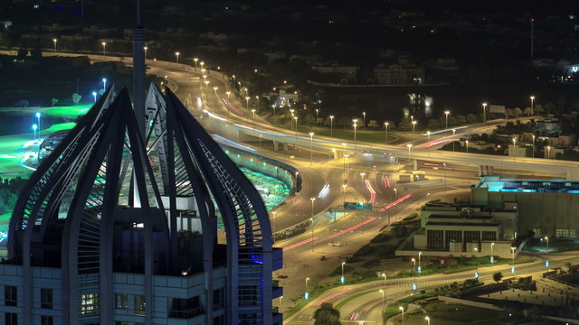 Highway intersection at night with tower from rooftop timelapse