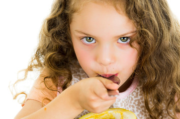 Cute little preschooler girl holding a passion fruit half