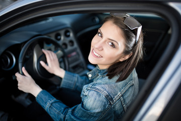 Fototapeta na wymiar Young woman in car going on road trip.Driver license exam