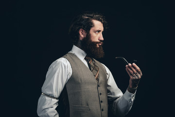 Elegant Man in Formal Suit Holding Tobacco Pipe