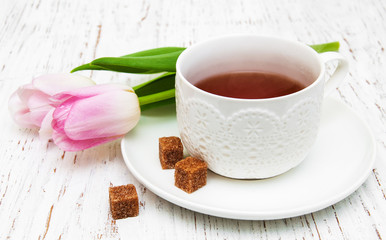Cup of tea and pink tulips