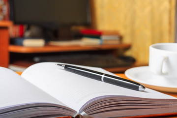 Diary on the table and a PC