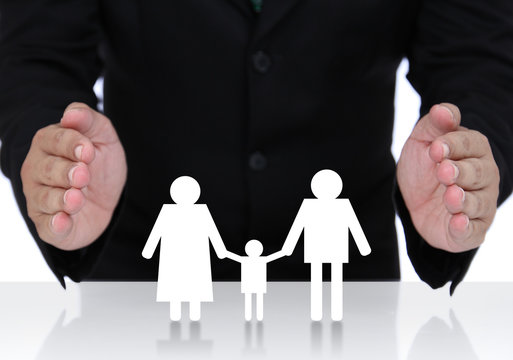 Businessman hand protect  family