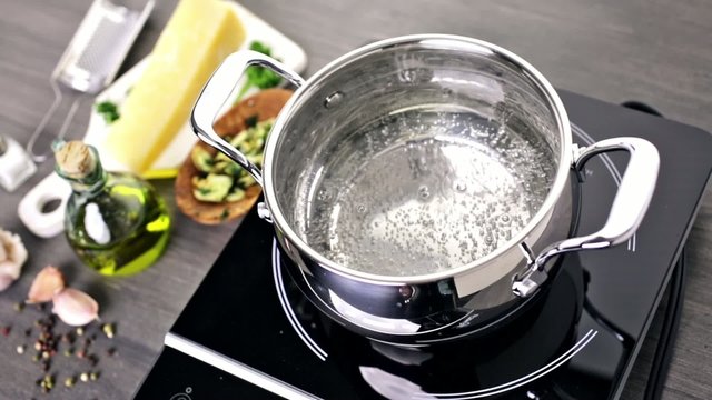 Cooking organic pasta with garlic herbs and parmesan cheese.
