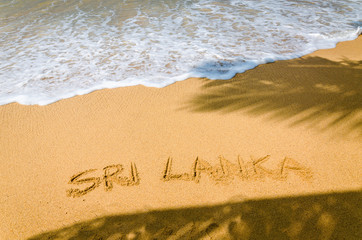 Sri Lanka written in a sandy on  tropical beach