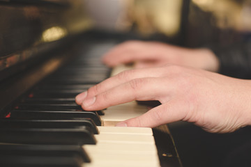 Fototapeta na wymiar Hands playing piano close-up oldschool vintage instagram filter