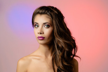 Naklejka premium Portrait of beautiful young woman with long curly hair