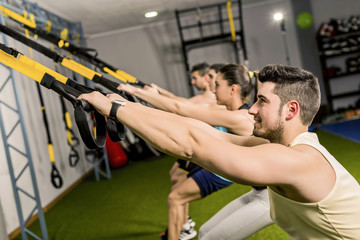 Elastic Rope exercises with trx rope at gym