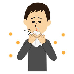 A young man sneezing, allergen flowing in the air