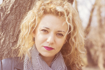 Young curly blond woman serious