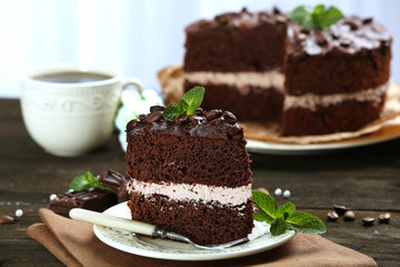 Delicious chocolate cake on table on light background