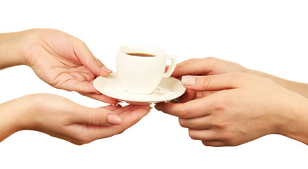 Female hands holding cup of coffee with saucer isolated on white