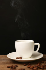 Cup of hot coffee with saucer