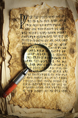 Grunge papers with hieroglyphics with magnifier close up