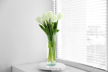 White beautiful tulips in light interior