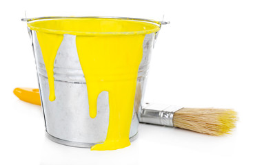 Bucket of yellow paint with brush isolated on white © Africa Studio
